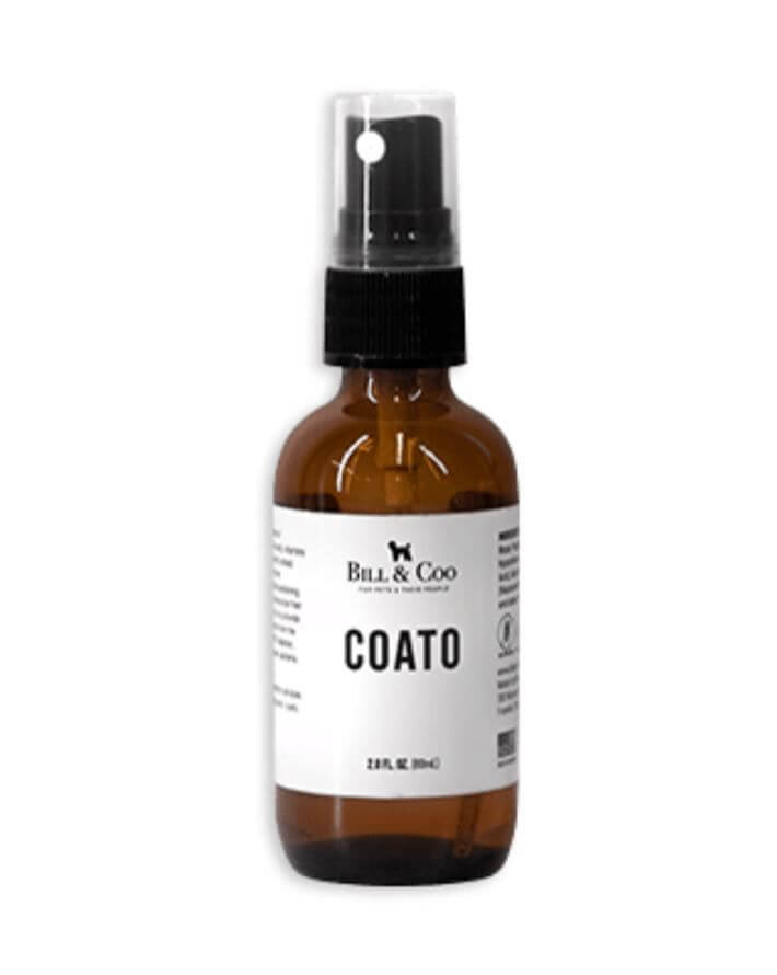 Coato environmental protective spray product bottle with amber glass, black spray nozzle, and white label showing 2 fl oz size, formulated with orthosilicic acid and hypochlorous acid by Dr. Christina Rahm for pets